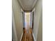 Well-lit hallway featuring wood-look floors, seamlessly connecting various rooms within the residence at 566 Shewsbury Ave, Las Vegas, NV 89178
