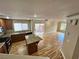 Modern kitchen with granite countertops, stainless steel appliances, and an island, with sliding door access to outdoor patio at 566 Shewsbury Ave, Las Vegas, NV 89178
