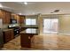 Modern kitchen with granite countertops, stainless steel appliances, and an island, with sliding door access to outdoor patio at 566 Shewsbury Ave, Las Vegas, NV 89178