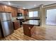 Modern kitchen with granite countertops, stainless steel appliances, and an island, with sliding door access to outdoor patio at 566 Shewsbury Ave, Las Vegas, NV 89178