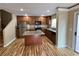 Modern kitchen with granite countertops, stainless steel appliances, an island, and an adjacent staircase to the upper level at 566 Shewsbury Ave, Las Vegas, NV 89178