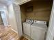 Convenient laundry closet with washer and dryer hookups and shelving for storage solutions at 566 Shewsbury Ave, Las Vegas, NV 89178
