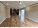 Spacious living room featuring wood floors that seamlessly connects to an open kitchen with sliding door access to the patio at 566 Shewsbury Ave, Las Vegas, NV 89178