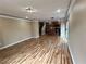 Spacious living room featuring wood floors that seamlessly connects to an open kitchen with sliding door access to the patio at 566 Shewsbury Ave, Las Vegas, NV 89178