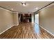 Spacious living room featuring wood floors that seamlessly connects to an open kitchen with sliding door access to the patio at 566 Shewsbury Ave, Las Vegas, NV 89178