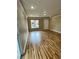 Bright living room with wood-look floors, a window and a door, offering modern living at 566 Shewsbury Ave, Las Vegas, NV 89178