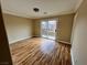 Spacious living room featuring wood-look floors, a sliding glass door, and ample natural light at 566 Shewsbury Ave, Las Vegas, NV 89178