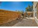 A cozy backyard with a grill, a small seating area, and a low block wall at 5916 Sierra Cliff St, North Las Vegas, NV 89031