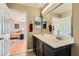 Bathroom with a double sink vanity near a bedroom with hardwood floors at 5916 Sierra Cliff St, North Las Vegas, NV 89031