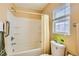 A clean and functional bathroom with a shower-tub combo and window at 5916 Sierra Cliff St, North Las Vegas, NV 89031