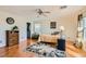 Relaxing bedroom includes wood floors, a ceiling fan, and large windows for a comfortable and airy ambiance at 5916 Sierra Cliff St, North Las Vegas, NV 89031