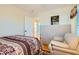 Bedroom with a comfortable chair and hardwood floors that leads to the bathroom at 5916 Sierra Cliff St, North Las Vegas, NV 89031