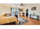 Serene bedroom boasts wood floors, a ceiling fan, and neutral decor, offering a cozy place to unwind and rest at 5916 Sierra Cliff St, North Las Vegas, NV 89031