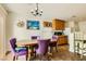 Quaint dining room with four chairs, wood cabinets and a decorative clock at 5916 Sierra Cliff St, North Las Vegas, NV 89031