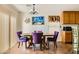 Well-lit dining area with four chairs, vertical blinds and a chandelier at 5916 Sierra Cliff St, North Las Vegas, NV 89031