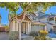 Inviting two-story home with a covered entryway, low maintenance front yard, and a two-car garage at 5916 Sierra Cliff St, North Las Vegas, NV 89031
