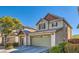 Lovely two-story home with a two-car garage, tidy landscaping, and a covered front porch at 5916 Sierra Cliff St, North Las Vegas, NV 89031