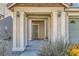 Inviting front porch with decorative columns and outdoor lighting, leading to the home's entrance at 5916 Sierra Cliff St, North Las Vegas, NV 89031
