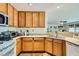 Efficient kitchen features wood cabinets and standard appliances at 5916 Sierra Cliff St, North Las Vegas, NV 89031