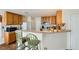 Open kitchen features counter seating, wood cabinets, and standard appliances at 5916 Sierra Cliff St, North Las Vegas, NV 89031