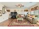 Bright living room features couches, a ceiling fan, a TV, and a patterned rug at 5916 Sierra Cliff St, North Las Vegas, NV 89031
