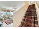 Welcoming staircase with carpet runner leads to the living area, offering a glimpse of the inviting space at 5916 Sierra Cliff St, North Las Vegas, NV 89031