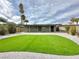 Well-maintained backyard featuring artificial grass and privacy fence at 604 N Minnesota St, Las Vegas, NV 89107