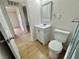 Bathroom featuring a shower/tub combo, a vanity, and light wood-look flooring at 604 N Minnesota St, Las Vegas, NV 89107