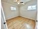 This bedroom features wood floors, a ceiling fan, and natural light from the windows at 604 N Minnesota St, Las Vegas, NV 89107