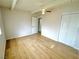 Bedroom with light wood-look floors, ceiling fan, and two windows at 604 N Minnesota St, Las Vegas, NV 89107