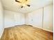 Bedroom featuring a ceiling fan, a window, and light wood-look floors and white trim at 604 N Minnesota St, Las Vegas, NV 89107