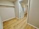 An empty walk-in closet featuring light wood-look floors and simple shelving and white trim at 604 N Minnesota St, Las Vegas, NV 89107