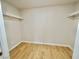 An empty walk-in closet featuring light wood-look floors and simple shelving at 604 N Minnesota St, Las Vegas, NV 89107