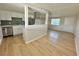 Bright kitchen featuring white cabinetry, stainless steel appliances, and light wood-look floors at 604 N Minnesota St, Las Vegas, NV 89107