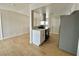 An open-concept kitchen with modern appliances and light wood-look floors seamlessly flowing into the adjacent living area at 604 N Minnesota St, Las Vegas, NV 89107