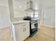 Kitchen featuring stainless steel appliances, white cabinets, and laminate flooring at 604 N Minnesota St, Las Vegas, NV 89107