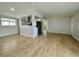 Open-concept living area with laminate wood flooring and a view of the kitchen at 604 N Minnesota St, Las Vegas, NV 89107