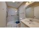 Well-lit bathroom with sink, toilet, and shower featuring sliding glass doors at 637 Del Prado Dr, Boulder City, NV 89005
