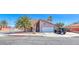 Inviting single-Gathering home with desert landscaping and a spacious driveway leading to an attached garage at 637 Del Prado Dr, Boulder City, NV 89005