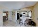 Cozy kitchen with white cabinets, breakfast bar, and modern black appliances at 637 Del Prado Dr, Boulder City, NV 89005