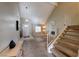 Comfortable living room with a fireplace, staircase, and large windows providing plenty of natural light at 637 Del Prado Dr, Boulder City, NV 89005