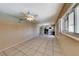 Bright living room with tile flooring and a window with shutters, open to the kitchen at 637 Del Prado Dr, Boulder City, NV 89005