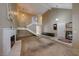Spacious living room with a white brick fireplace, staircase, and ample natural light from large windows at 637 Del Prado Dr, Boulder City, NV 89005