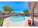 Pool and hot tub surrounded by desert landscaping, with a covered patio on the side at 637 Del Prado Dr, Boulder City, NV 89005