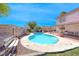 Inviting backyard pool with a concrete surround, bench seating, and desert landscaping at 637 Del Prado Dr, Boulder City, NV 89005
