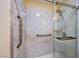 Modern shower with glass door, marble tile, and convenient grab bars at 637 Del Prado Dr, Boulder City, NV 89005