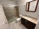 A modern bathroom featuring a glass-enclosed shower, vanity with dark cabinets and granite countertops at 6800 E Lake Mead Blvd # 2011, Las Vegas, NV 89156