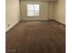 This cozy bedroom offers neutral paint, carpeted floors, and natural light from a large window at 6800 E Lake Mead Blvd # 2011, Las Vegas, NV 89156