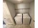 A convenient laundry room with washer, dryer, and overhead shelf at 6800 E Lake Mead Blvd # 2011, Las Vegas, NV 89156