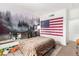 Cozy bedroom with a scenic forest mural, American flag, and plush textures at 6809 Cobre Azul # 201, Las Vegas, NV 89108